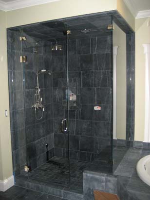 Black tiled shower with a black mosaic tile floor