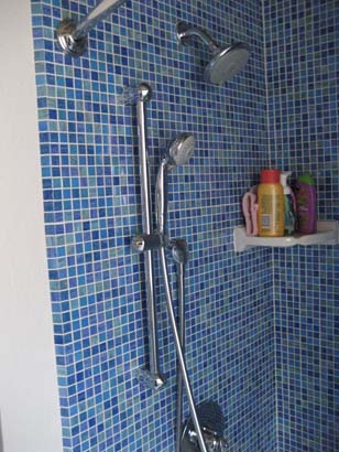 Blue mosaic tile with stainless steel shower fixtures