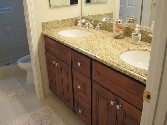 Tan granite counter on a refaced light wood grain