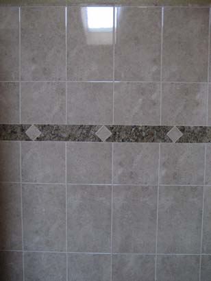 White tile on a black mosaic tile line in the middle